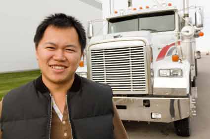 Truck Driver Smiles by Truck Photo
