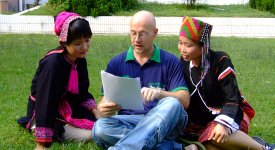 Overseas English Teacher Teaching Students on Lawn Photo