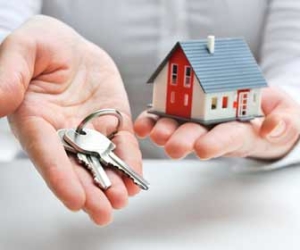 Real Estate Agent With Keys And House In Hands Picture