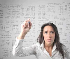Woman Doing Calculations To Set Freelance Rate
