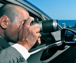 private investigator taking photo from car window picture