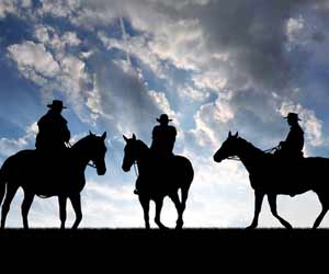 Three Dude Ranch Wranglers on Horses