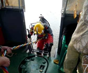 Commercial Diver entering water photo