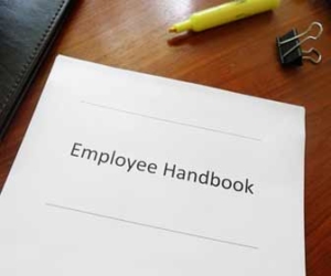 Employee handbook sitting on desk with highlighter image