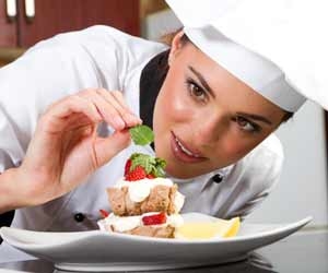 Female Chef Putting The Final Touches on a Dessert Plate