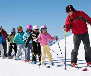 Ski Instructor Leading Youth Students during Ski School Lesson