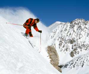 Skier Skiing Steep Ski Slope in Utah