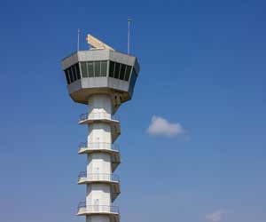 Air traffic control tower against blue sky