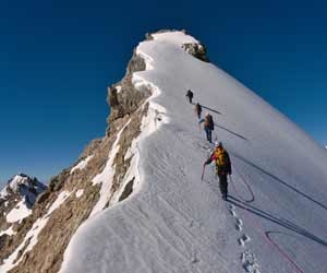 Team of mountaineers climbing a snowy mountain