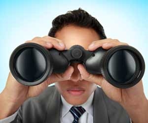 Job recruiter with massive binoculars looking for job seekers
