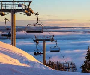 Chairlift rising above the clouds at ski resort