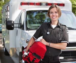 Paramedic standing in front of ambulance ready for work