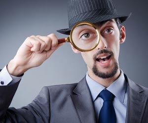 Detective with magnifying glass over right eye