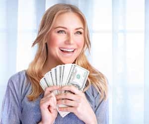 Happy woman with handfuls of cash