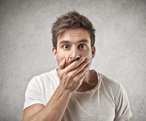 Job seeker covers mouth after receiving bad news