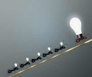 Line of ants with lightbulbs following a bigger ant with a bigger lightbulb