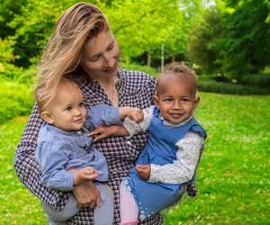 American Au Pair Hold Two Babies in Germany
