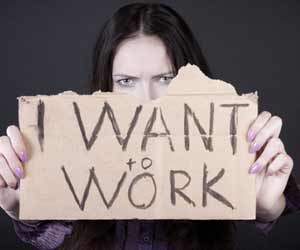 Job seeker holding cardboard sign saying "I want to work"