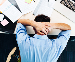 Frustrated HR professional with head on desk